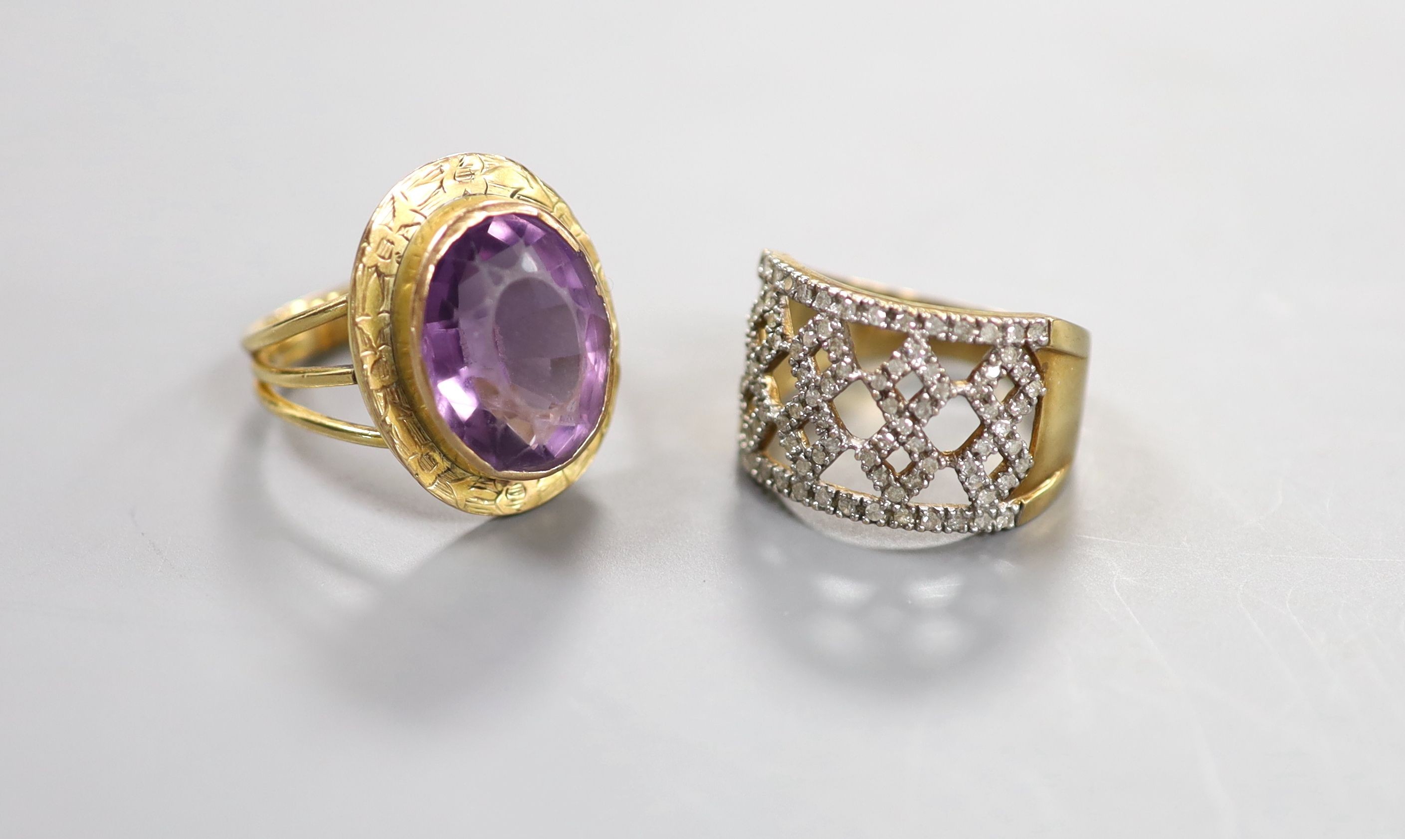 A modern pierced 9ct gold and diamond chip set dress ring, size P, gross 4.5 grams and a yellow metal and amethyst set oval dress ring, size N, gross 7.2 grams.
